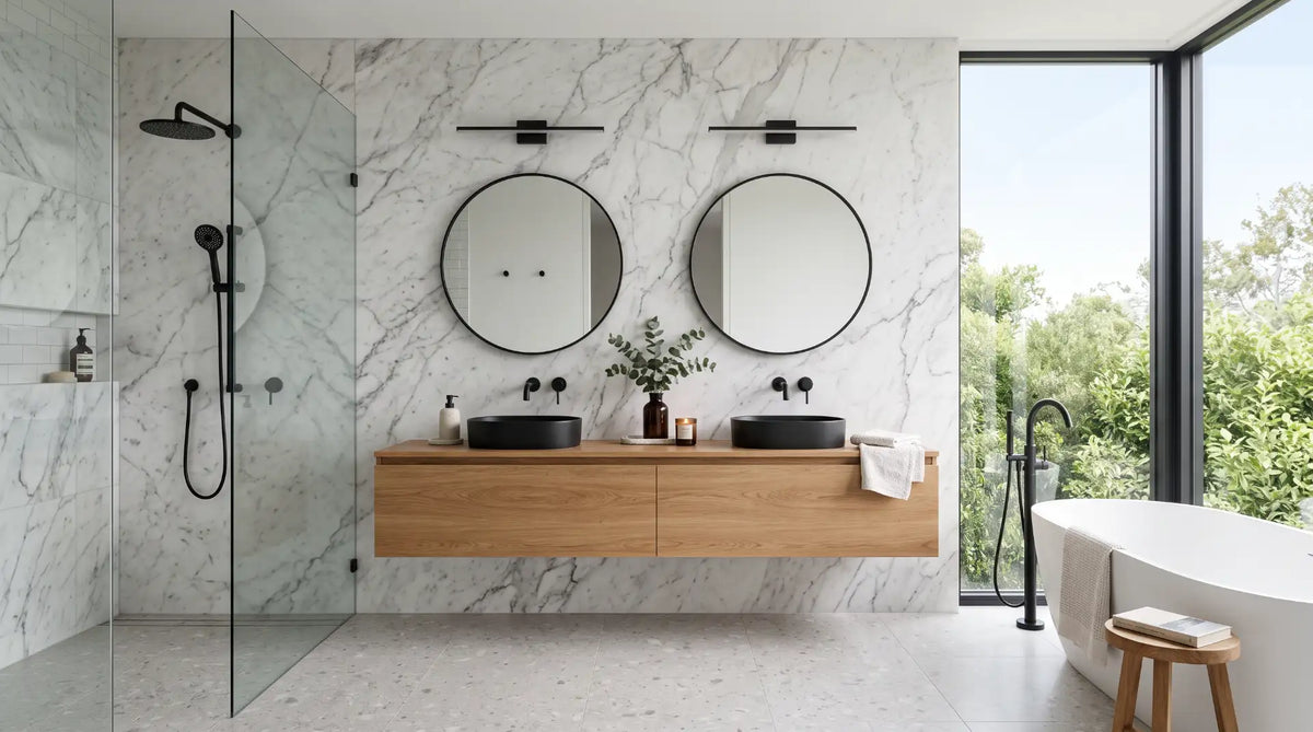 Modern luxury bathroom renovation featuring a natural stone accent wall, floating wood vanity, and high-end fixtures for a spa-like aesthetic.